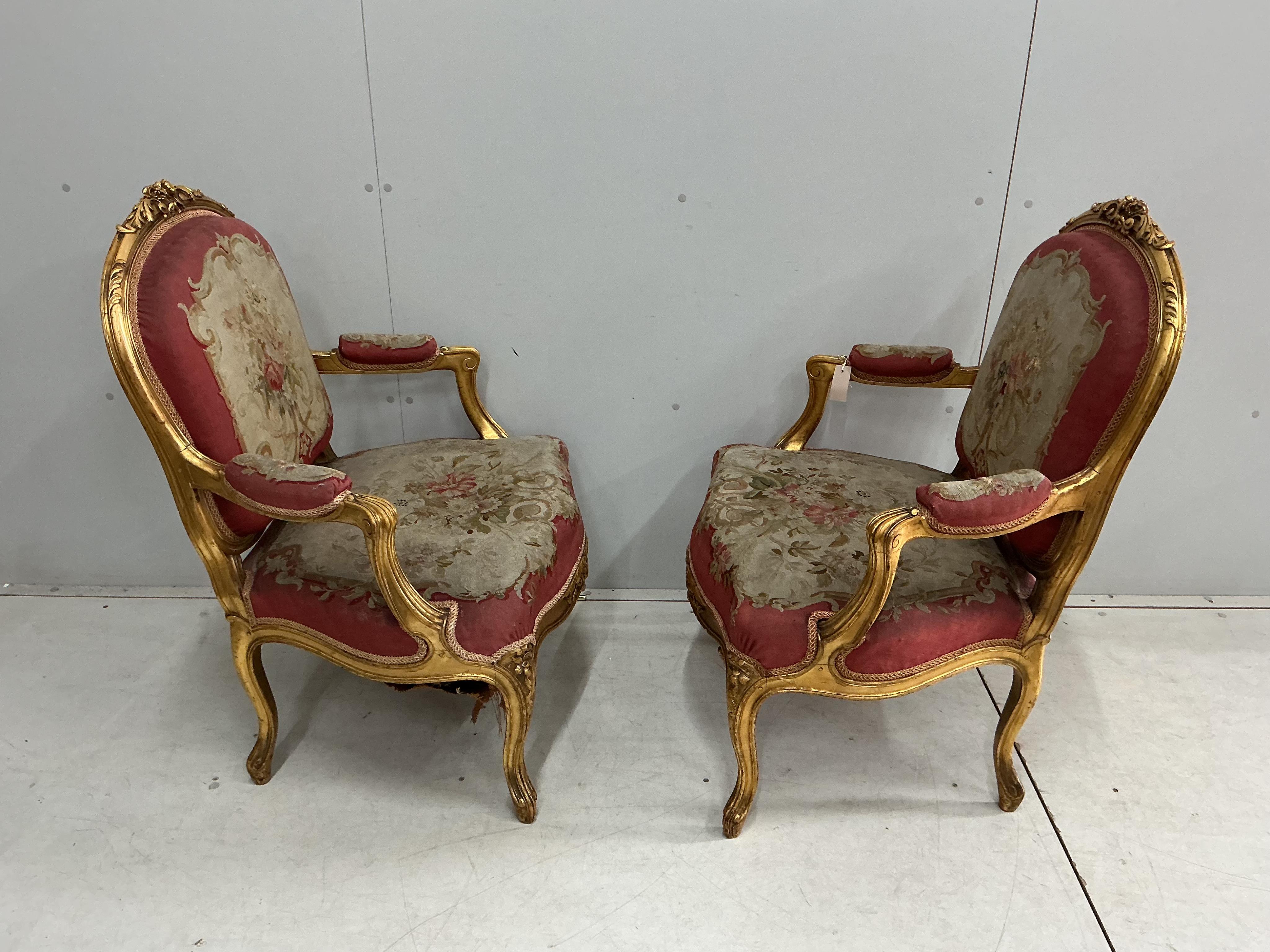 A pair of 18th century style giltwood and composition elbow chairs with petit point tapestry seats and backs, width 74cm, depth 52cm, height 96cm